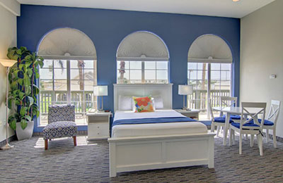 Alister Square Inn Deluxe Suite with cozy beds, modern furnishings, and vibrant wall