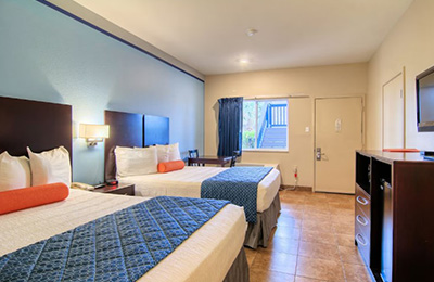 Spacious room with 2 full beds and a kitchenette at Alister Square Inn