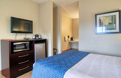 Spacious 1 Queen Handicap Room with tiled flooring and accessible bathroom at Alister Square Inn
